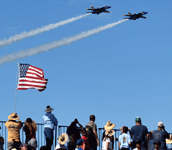 The two Blue Angels are about to fly over a grandstand at the Miramar Air Show...on September 24, 2022.
