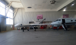 The Ikhana Predator B drone is parked near the Gulfstream III aircraft at NASA's Armstrong Flight Research Center...on May 31, 2016.