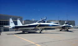 Another F-15 Eagle and an F/A-18 Hornet (not the same one that conducted the sonic boom demo a few hours earlier) parked on the tarmac.