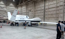 An RQ-4 Global Hawk UAV on display inside another hangar at NASA's Armstrong Flight Research Center...on May 31, 2016.