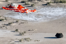 OSIRIS-REx's sample return capsule and its parachute sit on the desert floor at the Utah Test and Training Range, on September 24, 2023