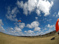 Now safely on the ground, my videographer films me and my tandem instructor as we come in for a landing at the drop zone...on October 4, 2018.