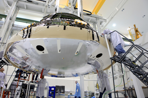 Engineers work on the Orion spacecraft inside the Operations and Checkout Building at NASA's Kennedy Space Center in Florida, on May 30, 2014
