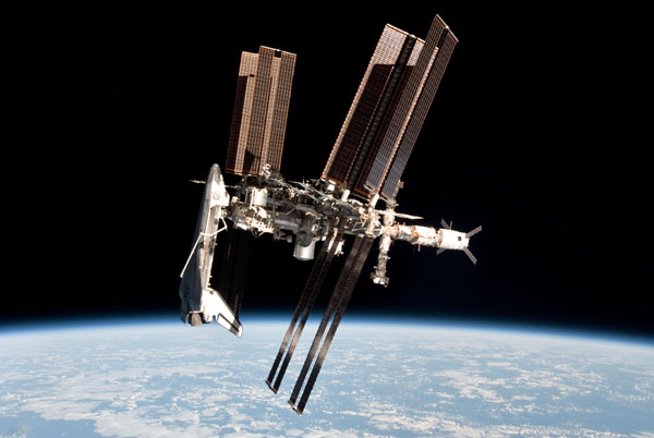 The International Space Station (ISS) with space shuttle Endeavour docked to it, as seen from a Russian Soyuz vehicle after it undocked from the ISS on May 23, 2011