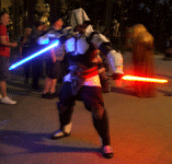 A fan dressed as an assassin from ASSASSIN'S CREED welds a Jedi and Sith lightsaber at Star Wars Celebration in Anaheim...on April 17, 2015.