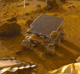 The Sojourner rover is deployed from the Pathfinder lander onto the surface of Mars on July 6, 1997