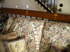 Window shades reflected the annular solar eclipse against a wall and furniture in my living room.