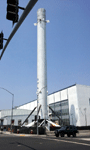 The older Falcon 9 booster towers above the main building at SpaceX Headquarters...on August 25, 2016.