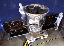 Engineers work on NASA's TESS spacecraft at the Orbital ATK facility in Dulles, Virginia