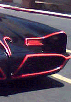 A frontal view of the Batmobile with Stage 31 in the background