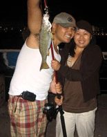 Ryan and Sarina posing with one of two fish that Sarina caught that night.