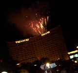 Fireworks shoot out from the roof of Treasure Island.