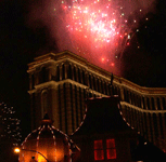 Fireworks shoot out from the roof of another hotel.