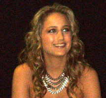 LEELEE SOBIESKI smiles up at a fan