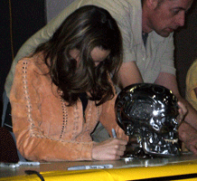 SUMMER GLAU signs the base of a TERMINATOR toy skull